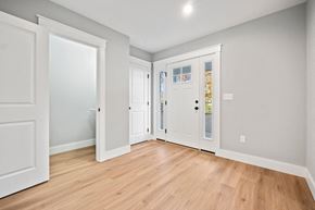 Saco triplex for rent - a living room with white doors and a wood floor