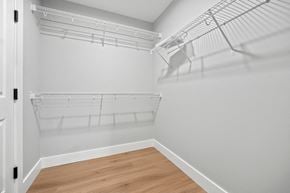 Saco triplex for rent - the closet in a bedroom of a house with white walls and wood floors