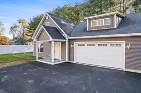 Saco triplex for rent - the front of a house with a white garage door