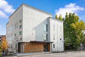 Biddeford apartment for rent - the exterior of a white building with a wooden facade