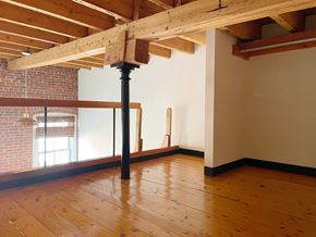 Portland apartment for rent - a living room with wood floors and exposed beams