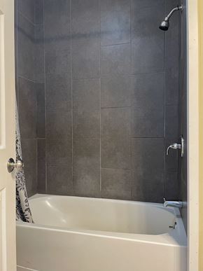 Portland apartment for rent - a bathroom with a shower and a bath tub