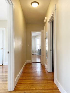 Portland apartment for rent - an empty hallway with wood flooring and white walls
