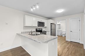 Westbrook apartment for rent - a kitchen with white cabinets and a granite counter top
