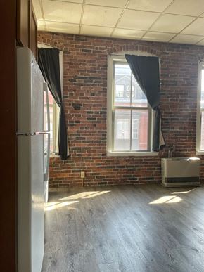 Portland apartment for rent - an empty room with a brick wall and a window
