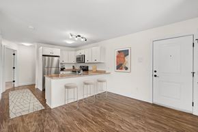 Westbrook apartment for rent - a living room with a kitchen and a bar with three stools