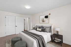 Westbrook apartment for rent - a bedroom with white walls and a white bed with gray pillows