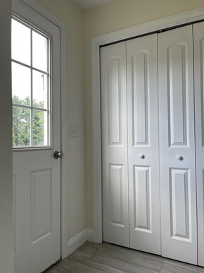 Gorham apartment for rent - A white door is on the left and a white door with a black handle is on the right.