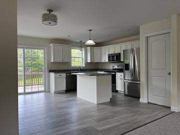 Gorham apartment for rent - A kitchen with a large island and stainless steel appliances.