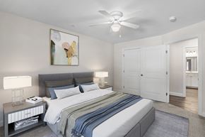 Brunswick apartment for rent - a bedroom with a large bed and a ceiling fan