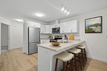 Scarborough apartment for rent - A kitchen with white cabinets and a granite countertop.
