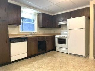 Gorham apartment for rent - a kitchen with white appliances and wooden cabinets