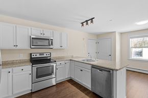 Cumberland Foreside apartment for rent - a kitchen with white cabinets and stainless steel appliances