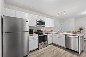 Westbrook apartment for rent - a kitchen with stainless steel appliances and white cabinets