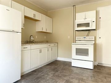 Portland apartment for rent - a kitchen with white appliances and white cabinets