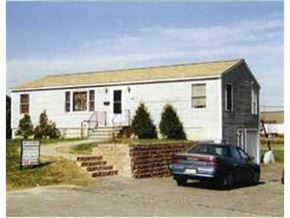 Portland apartment for rent - A white building with a car parked in front.