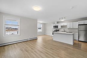Scarborough apartment for rent - A kitchen with white cabinets and a wooden floor.