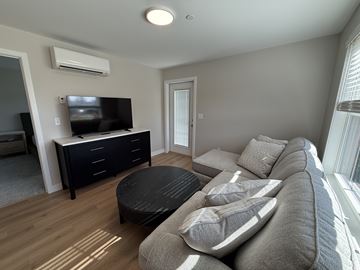 Scarborough apartment for rent - A living room with a grey couch and a black coffee table.