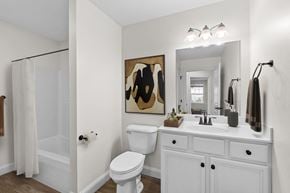 Westbrook apartment for rent - Bathroom with framed mirror and white cabinetry at Island View Apartments, Maine