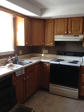 Portland apartment for rent - A kitchen with wooden cabinets and a black oven.