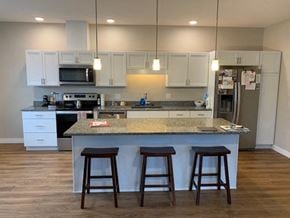 Scarborough condo for rent - a kitchen with an island and three bar stools