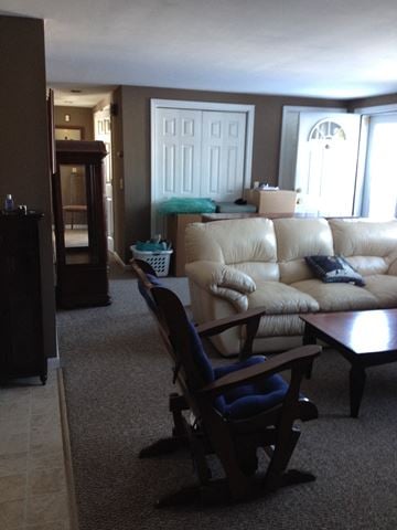 Portland apartment for rent - A living room with a tan couch and a wooden coffee table.
