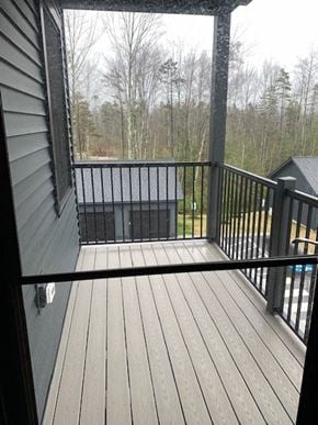 Scarborough condo for rent - a balcony with a wooden deck and a view of trees