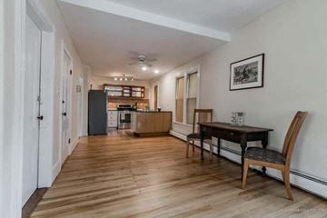 Portland apartment for rent - a living room and a kitchen with a table and chairs