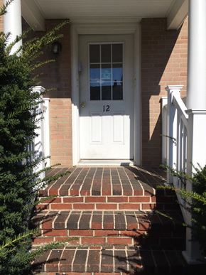 Portland apartment for rent - the front door of a brick house with a white door