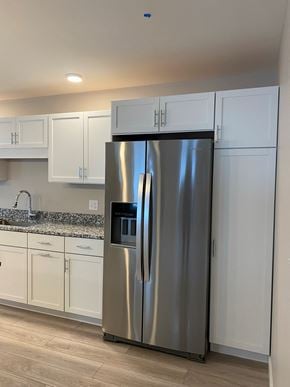 Scarborough condo for rent - A stainless steel refrigerator in a kitchen with white cabinets.