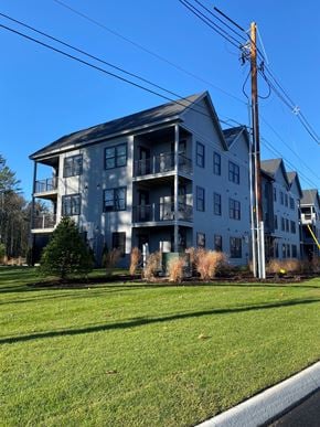 Scarborough condo for rent - A large two-story building with a balcony on the second floor.
