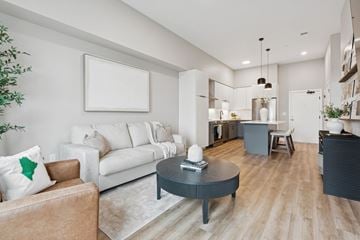Scarborough condo for rent - A modern living room with a brown leather couch and a white sofa.