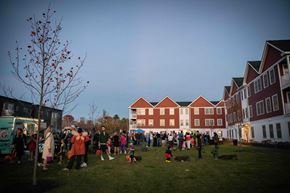 Scarborough apartment for rent - Community gathering with residents and food trucks at dusk at Hackamore North Apartments, Scarborough, Maine