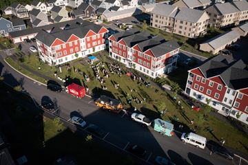 Scarborough apartment for rent - A red and white building with a green lawn in front.