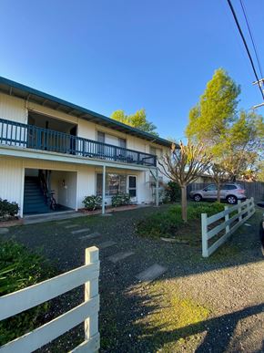 Sonoma apartment for rent - a white house with a white fence and a car parked in front of it