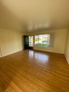 Sonoma apartment for rent - an empty living room with wood floors and a large window