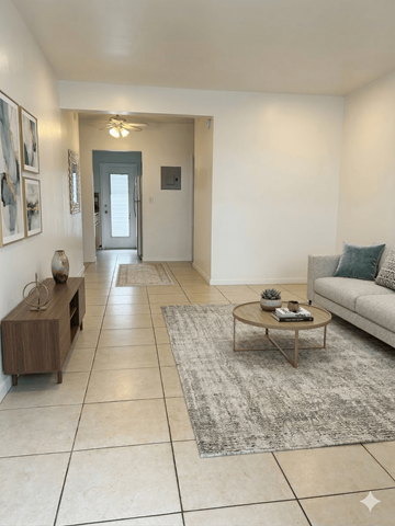 Miami Beach apartment for rent - A living room with a white couch and a coffee table.