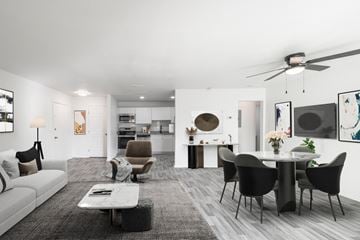 Jacksonville apartment for rent - A modern living room with a grey carpet and a white sofa.