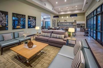Anaheim apartment for rent - A living room with a wooden coffee table and striped couches.