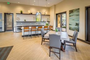 Irvine apartment for rent - a dining area with a table and chairs and a kitchen in the background