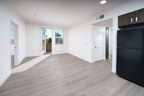 Sacramento apartment for rent - a living room with white walls and a black refrigerator