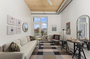 Sacramento apartment for rent - A living room with a couch, chairs, and a table.