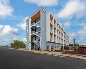 Sacramento apartment for rent - A modern building with the word "kind" written on it.
