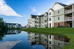 Grand Rapids apartment for rent - an apartment building reflected in a body of water