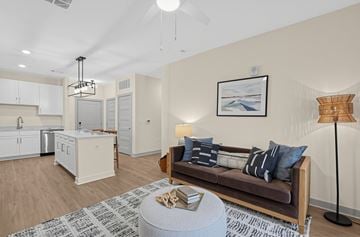 Charlestown apartment for rent - A living room with a brown couch and a grey ottoman.