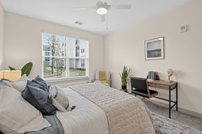 Charlestown apartment for rent - A bedroom with a large bed and a desk with a chair.
