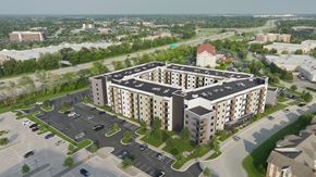 Louisville apartment for rent - A large apartment complex with a parking lot in front.