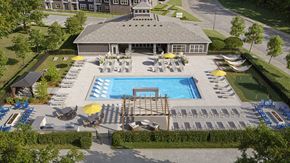 Lexington apartment for rent - A large outdoor swimming pool area with sun loungers and a building in the background.