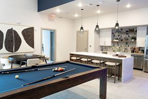 Franklin apartment for rent - A pool table is in the middle of a room with a bar and kitchen in the background.