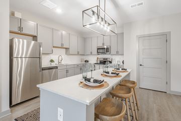 Lexington apartment for rent - A modern kitchen with a white countertop and stainless steel appliances.